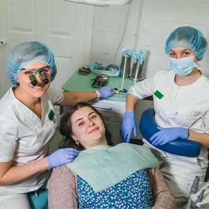 Lady smiles in dentist’s chair