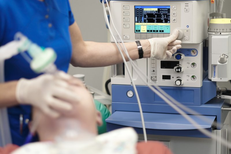 A dentist using sedation dentistry to keep a patient calm