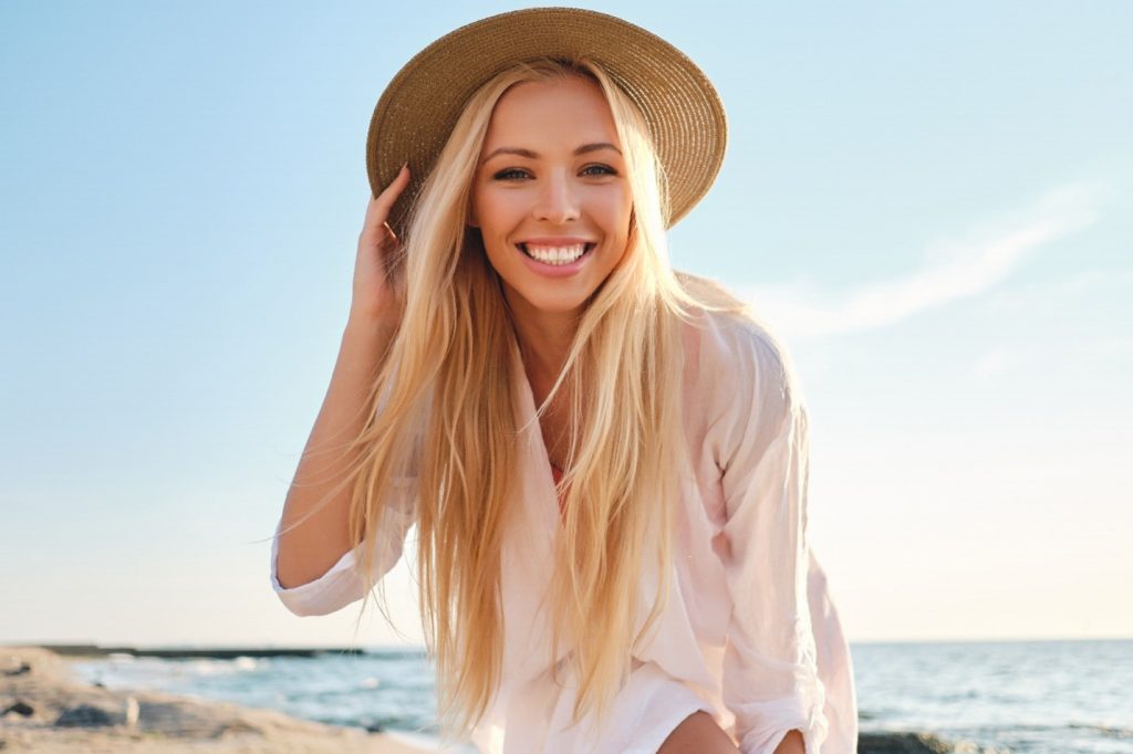 Woman at the beach enjoying summer vacation. 
